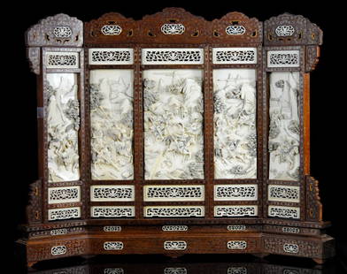 Turn of the century hand carved Chinese ivory screen: DESCRIPTION: Turn of the century hand carved Chinese ivory screen. Constructed from solid teak wood inlaid with bronze spiral design and hand carved ivory plaques with a foliate motif. The jewel of th