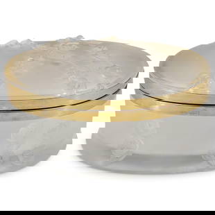 Lalique 'Coppelia' Oval Vanity Box: Lalique 'Coppelia' Oval Vanity Box20th century, FranceLalique 'Coppelia' hinged oval vanity box with gilt metal mounts, moulded in relief with garlands of roses tumbling down the sides. Marked "Laliqu