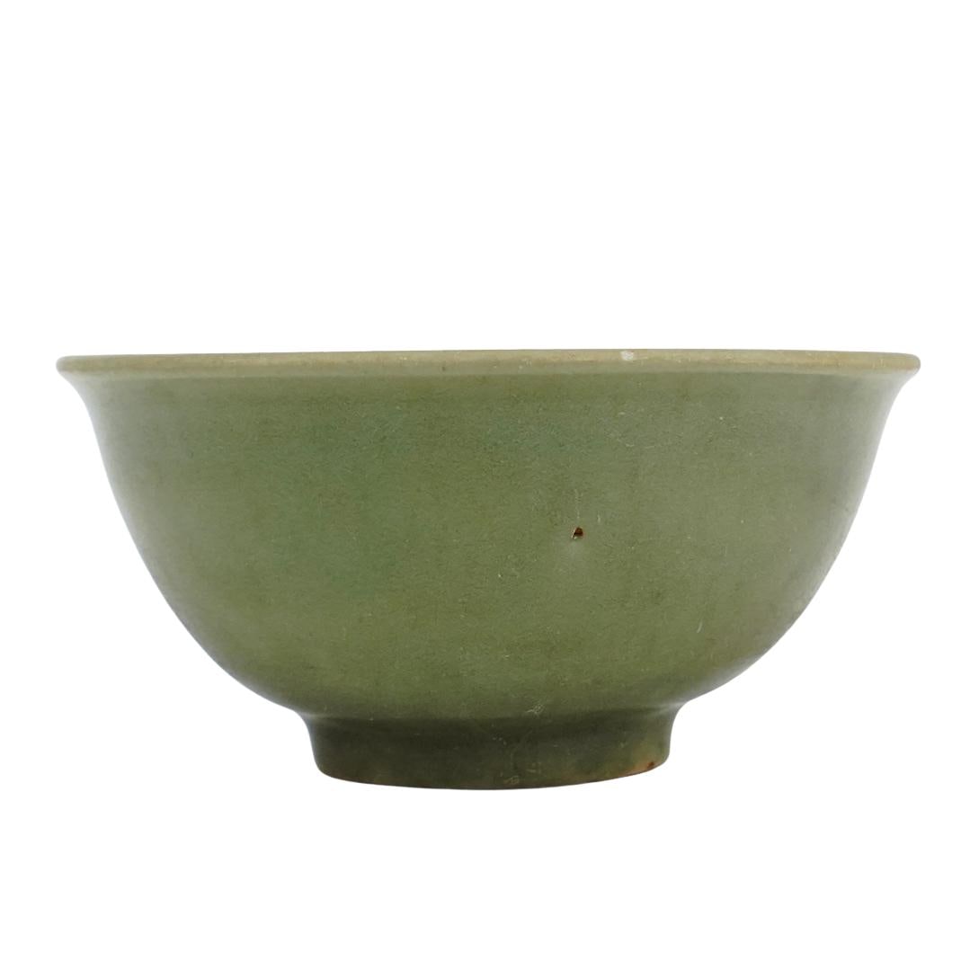 Antique Chinese Longquan Celadon Bowl: Antique Chinese Longquan Celadon BowlChina, 19th Century, possibly older.Antique Chinese Longquan Celadon Bowl. Found in Musi River Palembang. With rounded form, footed base, and signature on the unde