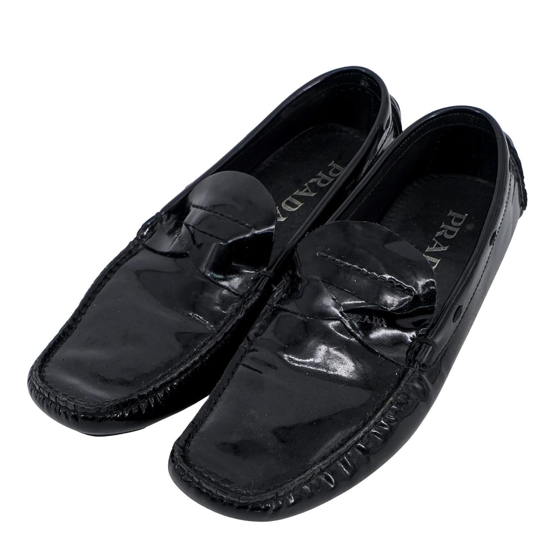 Prada Black Patent Leather Loafers: Prada Black Patent Leather Loafers20th century, ItalyA pair of black Prada patent leather loafers for men. They have a high-shine finish and are completed with a rubber outsole. The Prada logo is on t
