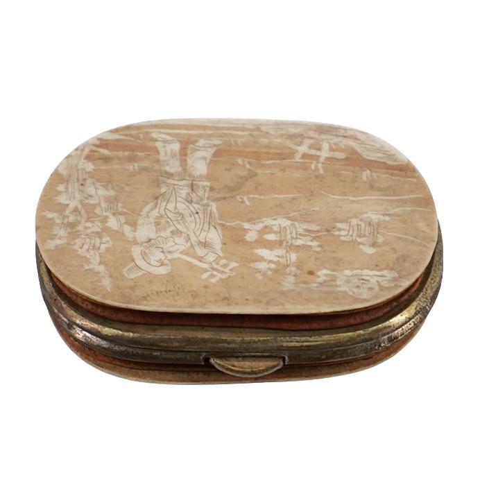 Antique Carved Bone Coin Wallet: Antique Carved Bone Coin WalletLate 19th-early 20th century, AsiaAn antique carved bone coin wallet with a figural depiction of a male figure playing a flute on one side. Inner lining is red and expan