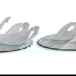 (3 Pcs) Lalique Crystal Swans On Oval Water Mirror: (3 Pcs) Lalique Crystal Swans On Oval Water Mirror20th century, FranceA pair of Lalique swan figurines is positioned on an oval mirror designed to resemble rippling water. One swan holds its head upri
