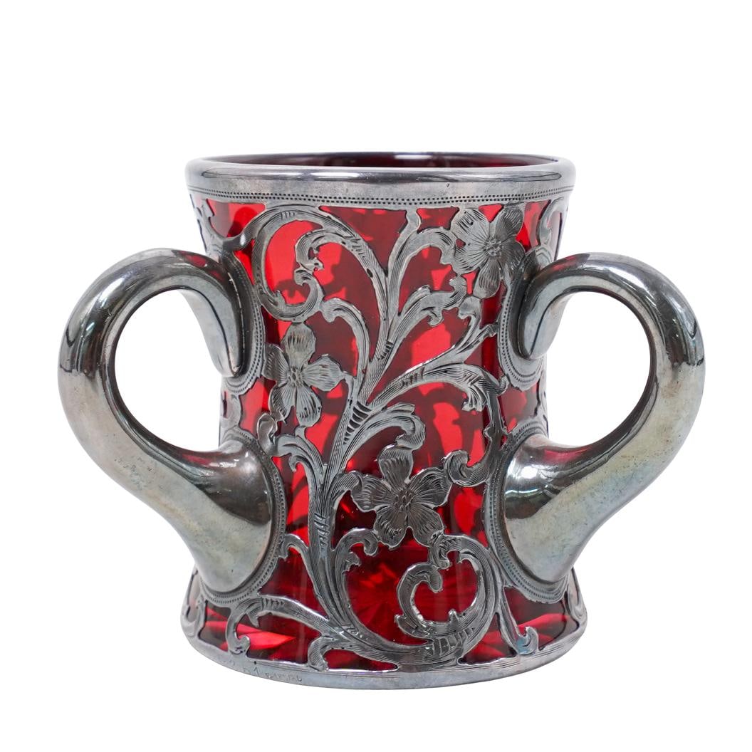 Steuben Sterling Silver Overlay Glass Loving Cup: Steuben Sterling Silver Overlay Glass Loving CupEarly 20th century, AmericanSteuben sterling silver overlay glass loving cup, designed with Steuben selenium red glass and ornate floral intertwined ste