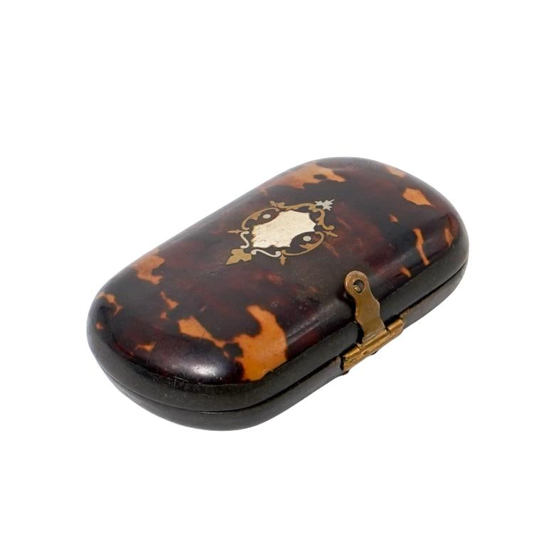 Antique French Napoleon III Tortoise Hued Pill Box: Antique French Napoleon III Tortoise Hued Pill BoxMid Late 19th Century, FranceAntique French Napoleon III tortoisehell hued pill box with oval form, and inlaid motifs.W: 2 3/4" D: 1 3/4" H: 3/4"