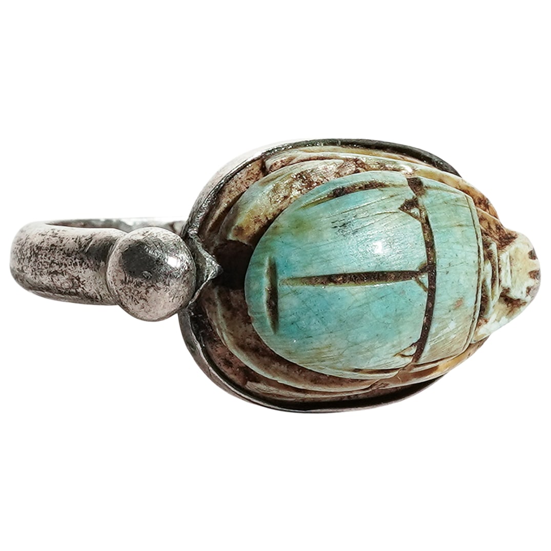 Egyptian Revival Silver & Turquoise Spinning Scarab Ring: Egyptian Revival Silver & Turquoise Spinning Scarab Ring19th-Early 20th c., EgyptAntique silver ring featuring a rotating carved turquoise scarab with hieroglyphs on the bottom. Metal tested silver. I
