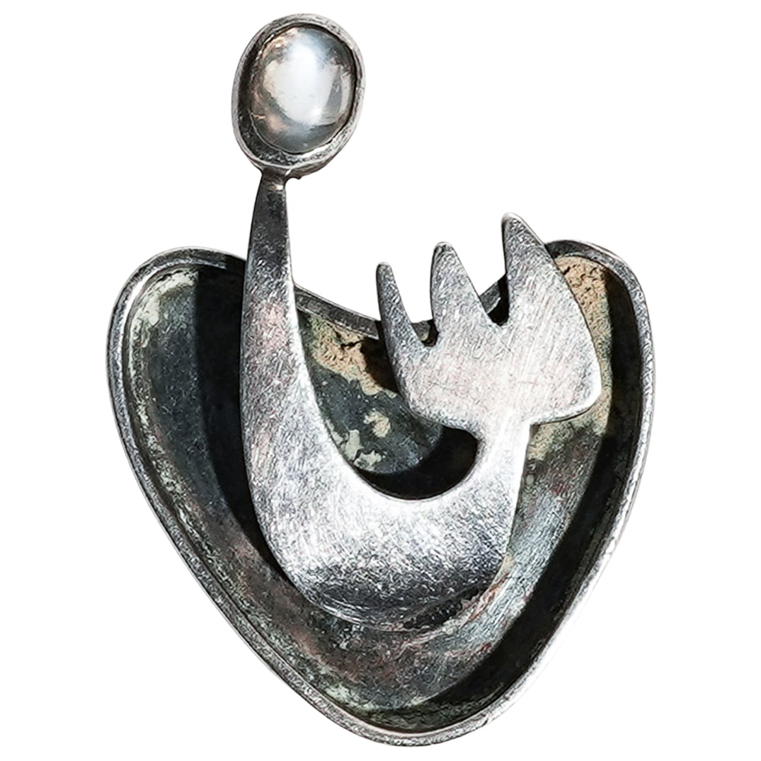 Ed Wiener Mid-Century Modernist Sterling & Moonstone Brooch: Ed Wiener Mid-Century Modernist Sterling & Moonstone Broochc. 1950s, USAAbstract modernist brooch designed by Ed Wiener made from sterling silver set with a moonstone cabochon. The back is stamped ste