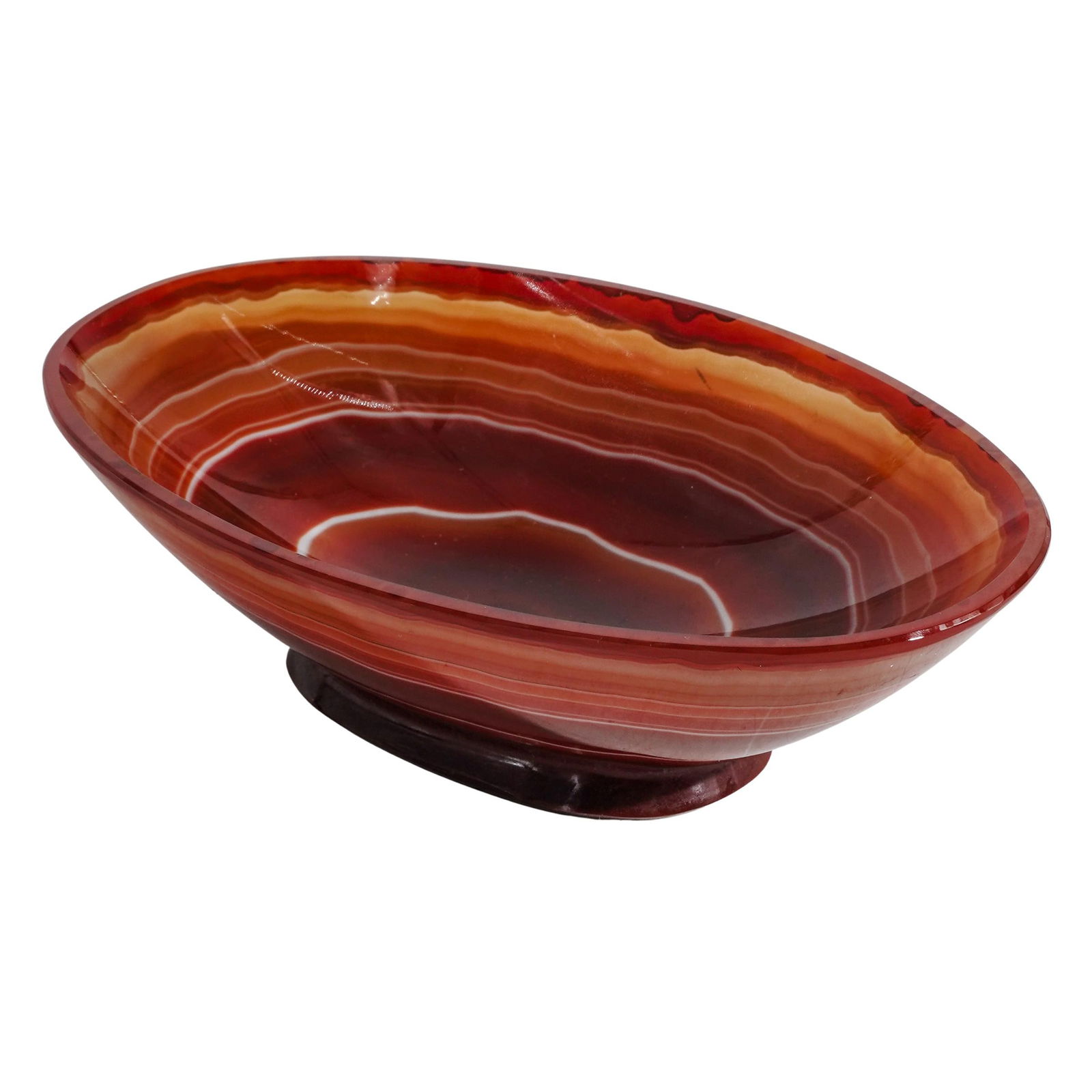 Carved Footed Agate Bowl: Carved Footed Agate Bowl20th century, ContinentalA carved agate bowl with natural concentric circular pattern. Footed.H 1 5/8" L 5 5/8" W 3 3/8"