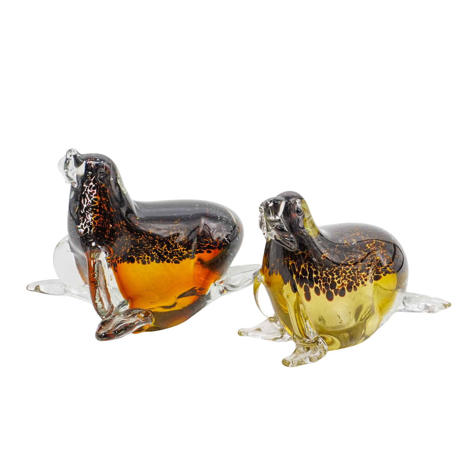 Pair of Art Glass Walrus Sculptures: Pair of Art Glass Walrus Sculptures Mid 20th century, Continental A pair of walrus sculptures featuring one larger than the other. Art glass construction in an "oil and vinegar" design featuring a yel
