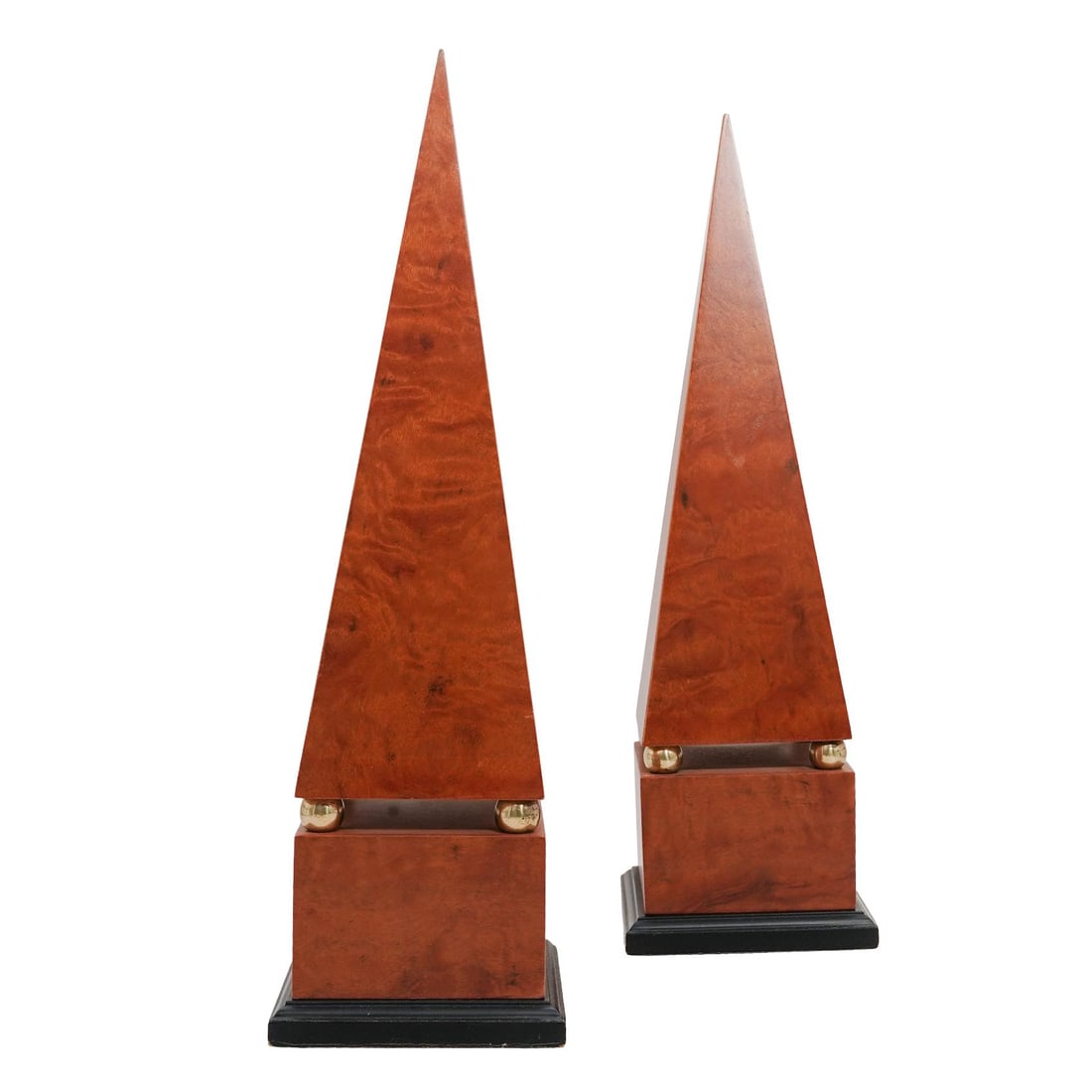 Pair of Mid-Century Wood Obelisk Statues: Pair of Mid-Century Wood Obelisk Statues20th c., ContinentalBrown wood obelisks with gold metal spheres and black bases.Approx. H: 16.35" W: 5.25" L: 5.25"