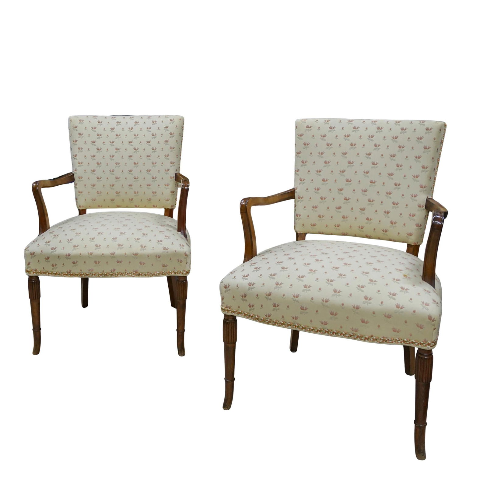 Pair of French Wood Upholstered Chairs: Pair of French Wood Upholstered Chairs20th century, EuropeanA pair of French chairs with cream upholstery covered with a delicate pink floral pattern and braided border around seat.H 35.25 W 21 L 24.7
