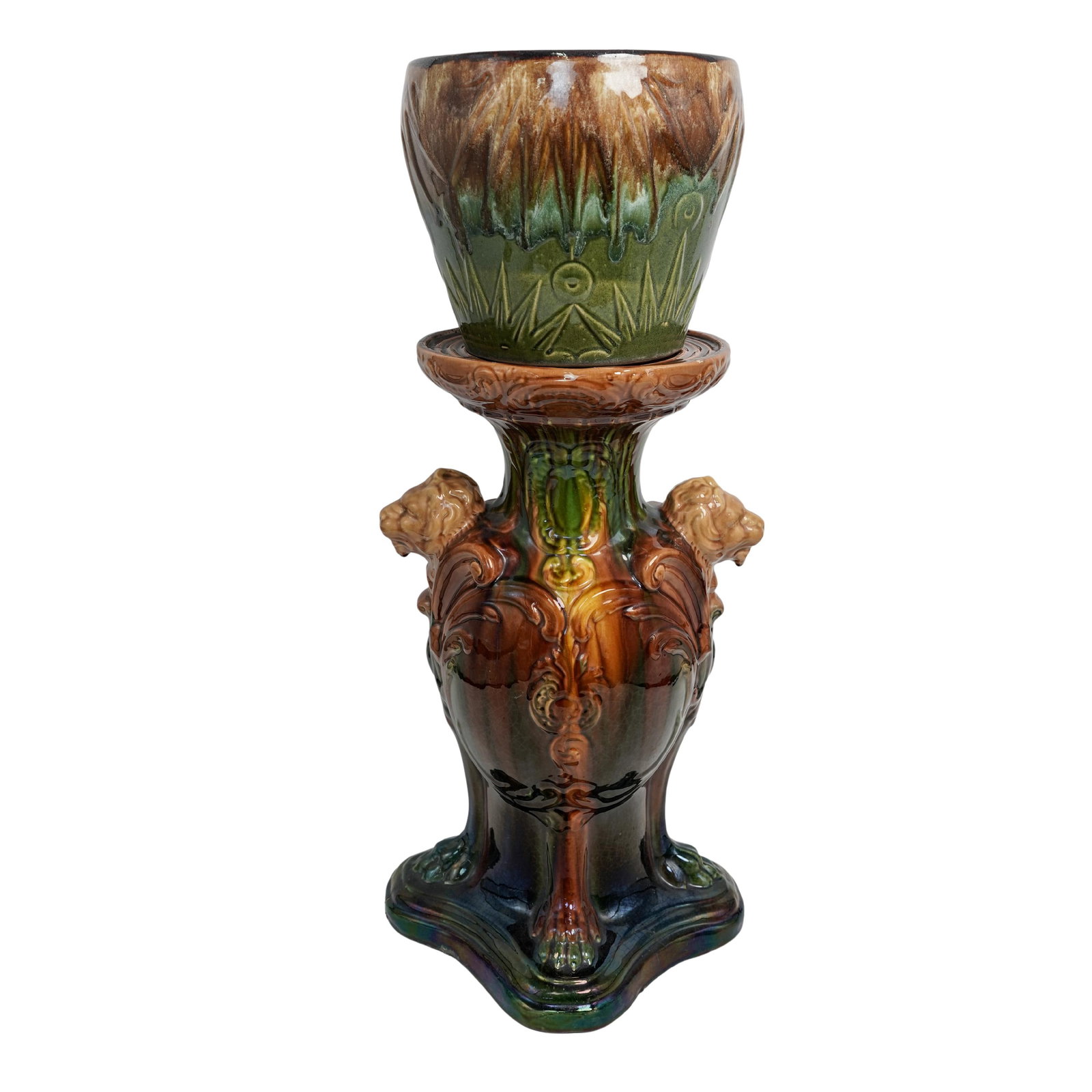 American Majolica Ceramic Jardiniere on Pedestal: American Majolica Ceramic Jardiniere on Pedestal20th century, AmericanAn American made Majolica ceramic jardiniere on a pedestal. Green and brown glaze with lion headed designs on pedestal complete wi