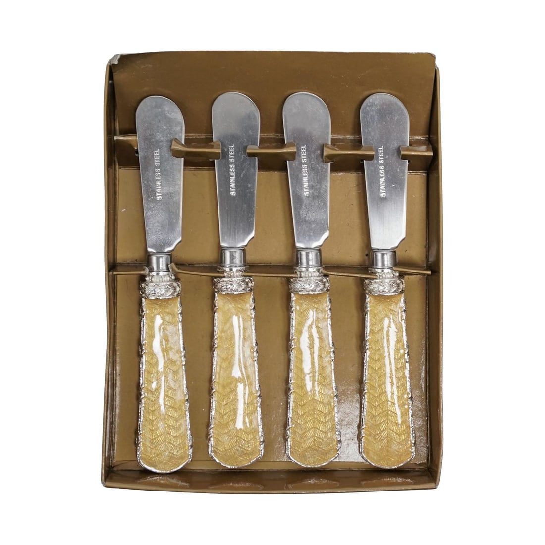 (4 pcs) Sherle Wagner Reed & Ribbon Guilloche Stainless Pate Knives: (4 pcs) Sherle Wagner Reed & Ribbon Guilloche Stainless Pate Knives20th century, AmericanA set of four Sherle Wagner (established 1945, American) yellow guilloche handled stainless steel pate knives f