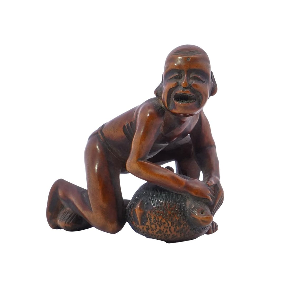 Japanese Boxwood Netsuke of Crouching Man Holding a Badger Teapot