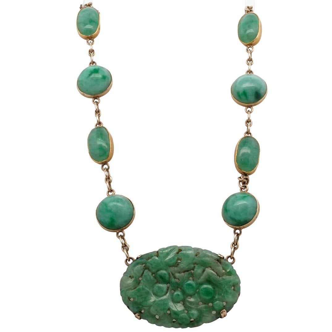 Chinese 14k & 20k Gold & Jadeite, Necklace: Chinese 14k & 20k Gold & Jadeite NecklaceEarly to Mid-20th Century. ChinaChinese 24k and 14k yellow gold necklace with inset Jadeite cabochons, terminating into a center oval form pendant with open-wo