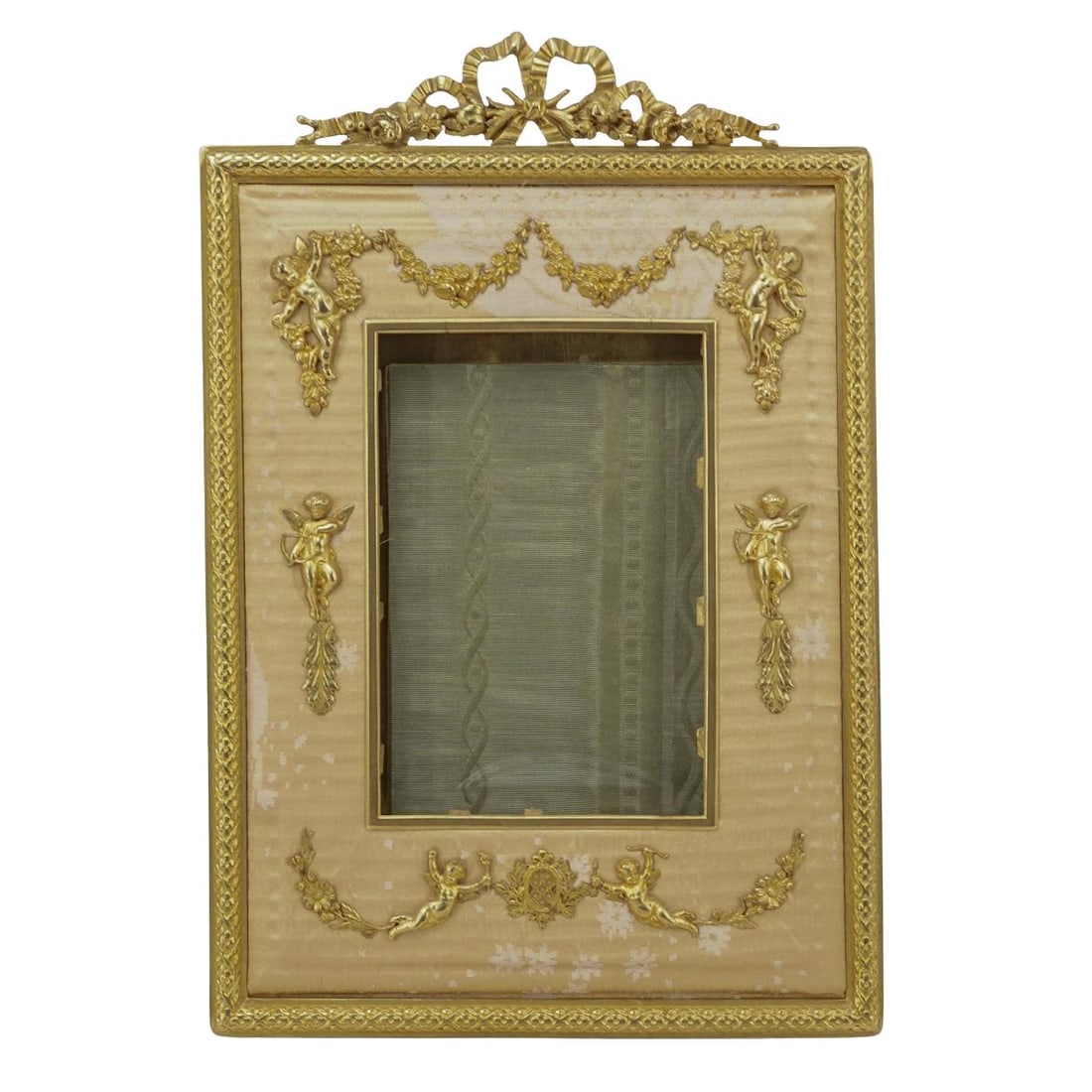 Antique French Gilt Desk Photo Frame: Antique French Gilt Desk Photo Frame1900-1909; France.Antique French gilt bronze desk easel picture frame, with gilt bronze mount and gold tone upholstered front. Behind the glass front, the back is c