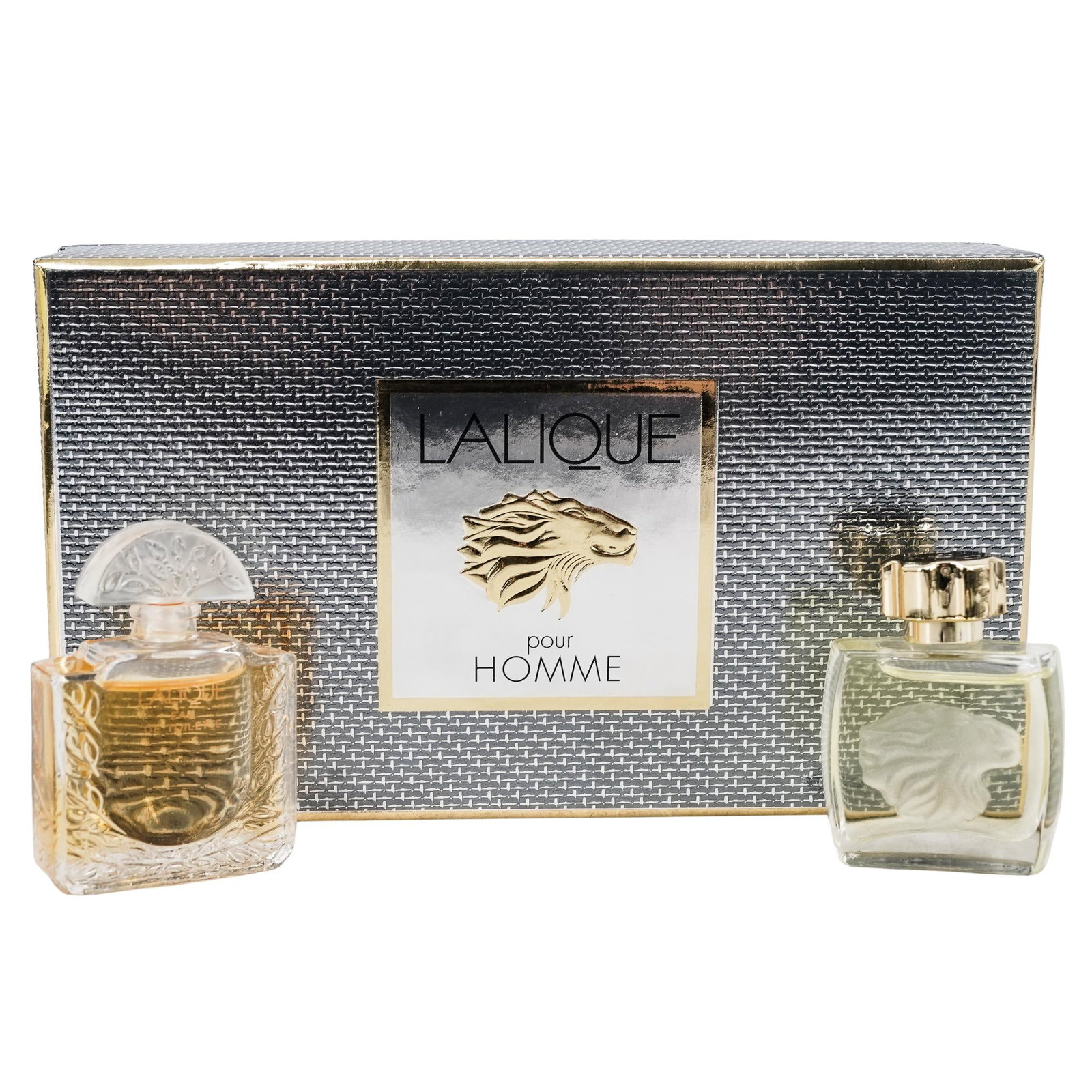 Pair of Boxed Lalique Pour Homme Perfumes: Pair of Boxed Lalique Pour Homme Perfumes 21st century, France A pair of boxed Lalique Pour Homme perfumes. One is in a Lalique frosted lion carved glass bottle marked "Lalique" on bottom. One is in a