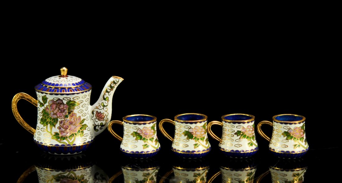 Vintage Chinese cloisonne miniature tea set: DESCRIPTION: Vintage Chinese cloisonne miniature tea set. Features a cloisonne over copper lidded tea pot with a white ground color and pink peony flowers. The set comes with four miniature cups with 