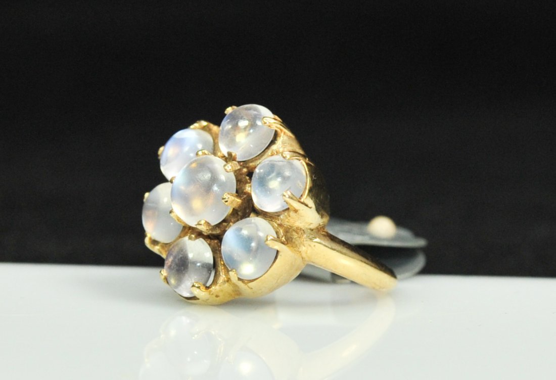 Ladies vintage 10k floral moonstone ring: DESCRIPTION: Ladies vintage 10k floral moonstone ring. Solid 10k band with a cluster of seven cabochon moonstones with an approx weight of 3.75cts. Floral design with each moonstone being prong set. S