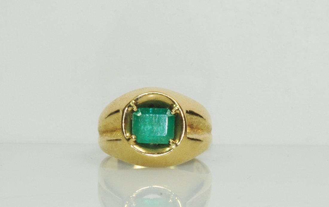 Large men's 14k yellow gold and emerald ring: DESCRIPTION: Large men's 14k yellow gold and emerald ring. Features a center 1.50ct Colombian emerald. Gorgeous color with minor inclusions. Mounted in a solid 14k yellow gold groove design setting. "