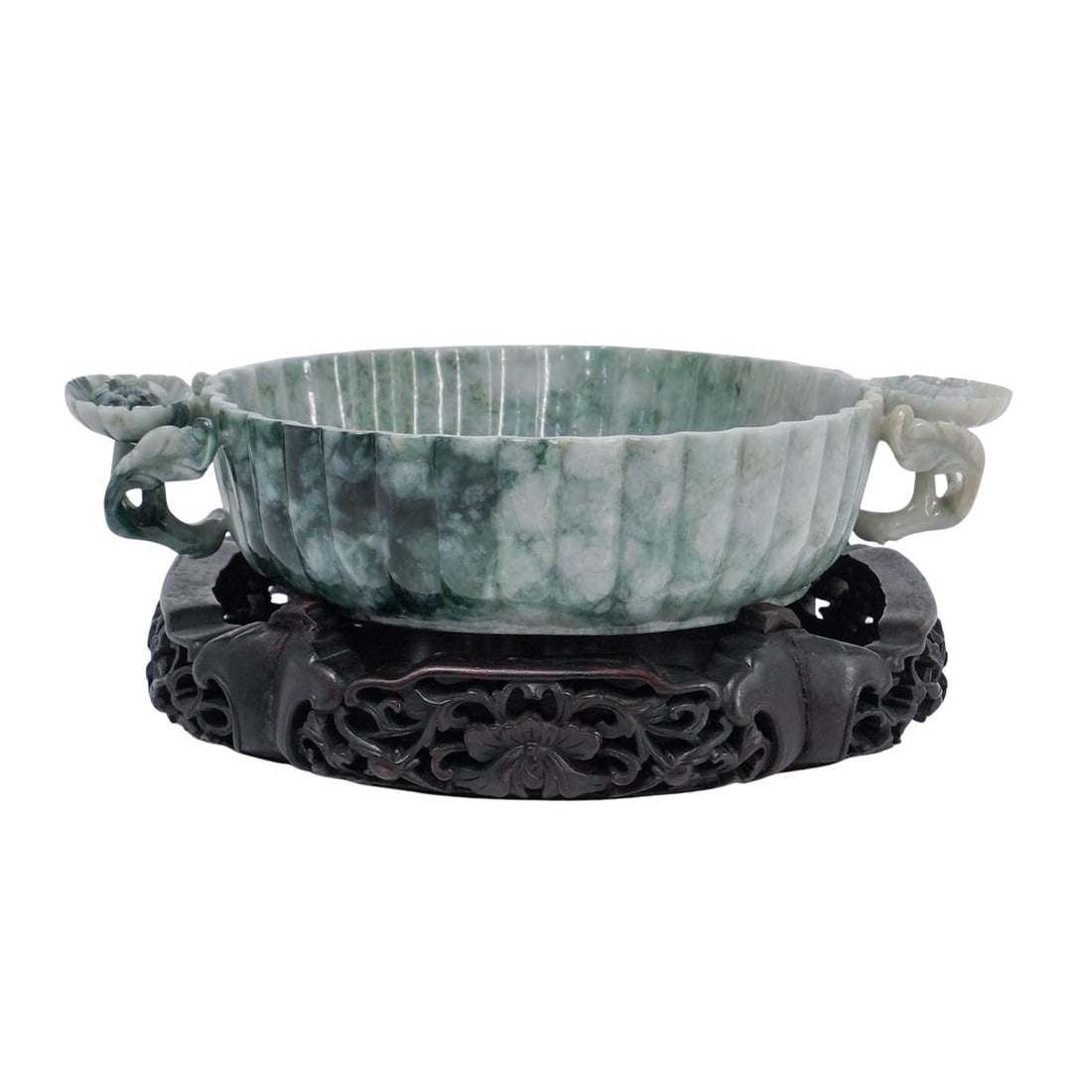 Mughal Style Jadeite Bowl on Wooden Stand: Mughal Style Jadeite Bowl on Wooden Stand 1910s-1940s, China Chinese Republic period Mughal style jadeite bowl featuring carved floral handles on a floral open-worked wooden stand. Bowl: H 2" L 9 3/4"