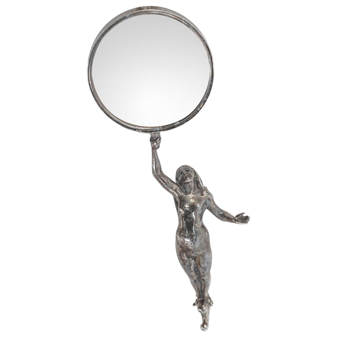 Antique Sterling Silver Female Nude Loupe Magnifier: Antique Sterling Silver Female Nude Loupe Magnifier20th Century. Continental.Antique Sterling silver loupe magnifier depicting a female nude figure in silver holding a rounded loupe with silver rim. M