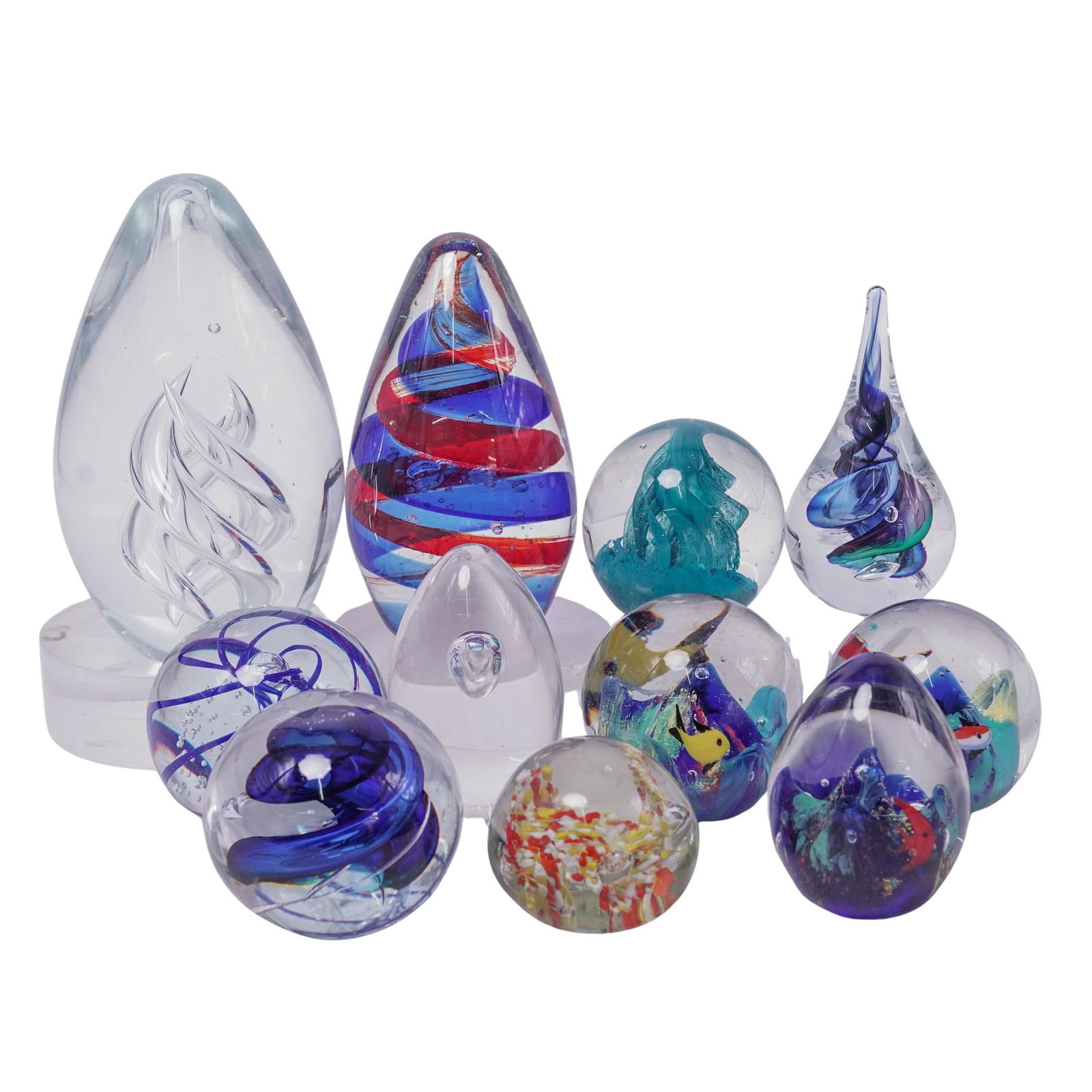 (11 pcs) Vintage Glass Paperweights: (11 pcs) Vintage Glass Paperweights20th century, American/ContinentalA set of eleven glass paperweights.x1 WheatonArts paperweight with a controlled bubble release and blue spiral pattern.x3 Glass pap