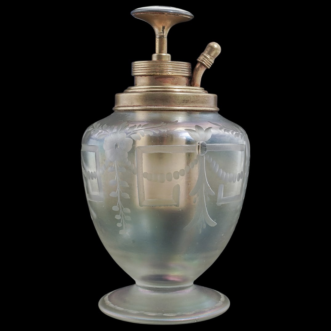 Iridescent Etched Steuben Style Glass Atomizer with Guilloche Enameled Piston: Iridescent Etched Steuben Style Glass Atomizer with Guilloche Enameled PistonLate 19th- early 20th century, USAAn iridescent transluscent glass perfume atomizer bottle with an etched floral decorative