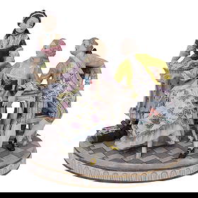 Capodimonte Porcelain: Capodimonte PorcelainLate 19th - early 20th, ItalyPorcelain figurine depicting an 18th-century scene with tree figures- a seated lady and gentleman engaged in conversation, attended by a maid offering