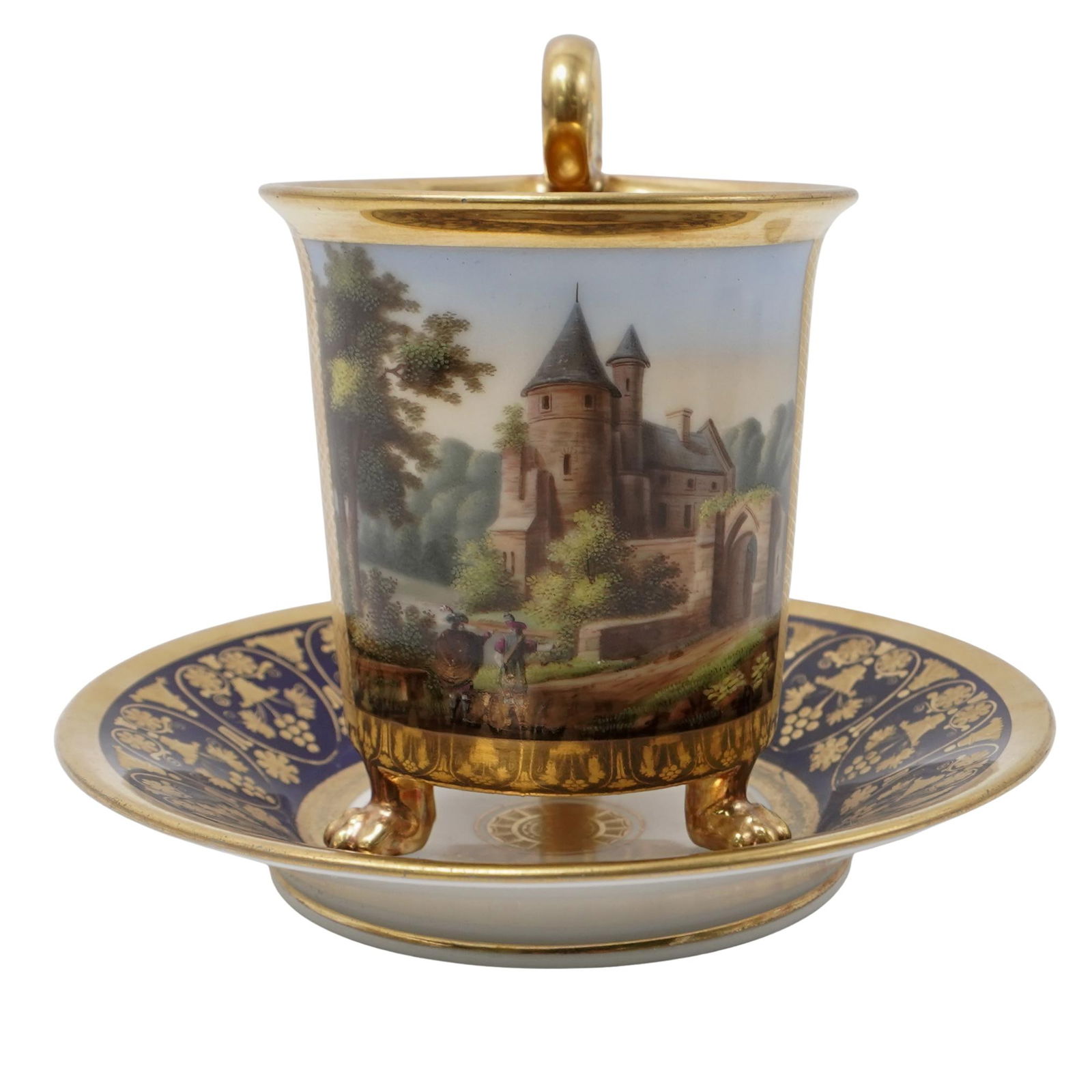 Antique Porcelain European Cup and Saucer.: Antique Porcelain European Cup and Saucer.20th century , EuropeanAntique Porcelain Cup and Saucer set. The design features hand painted castle scene on the cup and a elaborate cobalt blue and gold gil
