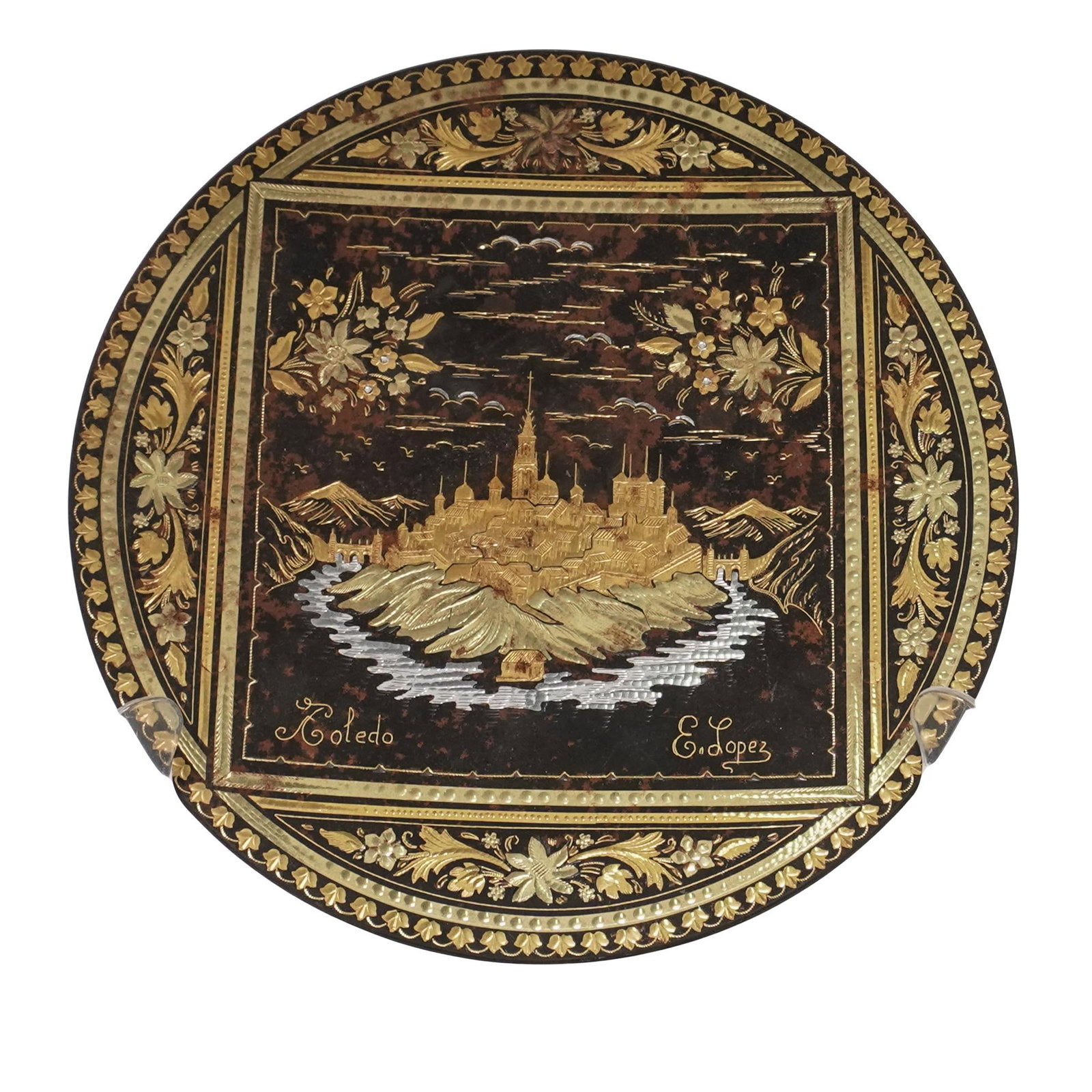 E. Lopez Toledo Spain Decorated Plate: E. Lopez Toledo Spain Decorated Plate 20th century, Spain Damascene decorated metal plate from Toledo Spain. The plate features a central image of Toledo cityscape, with the name "Toledo"and "E. Lopez