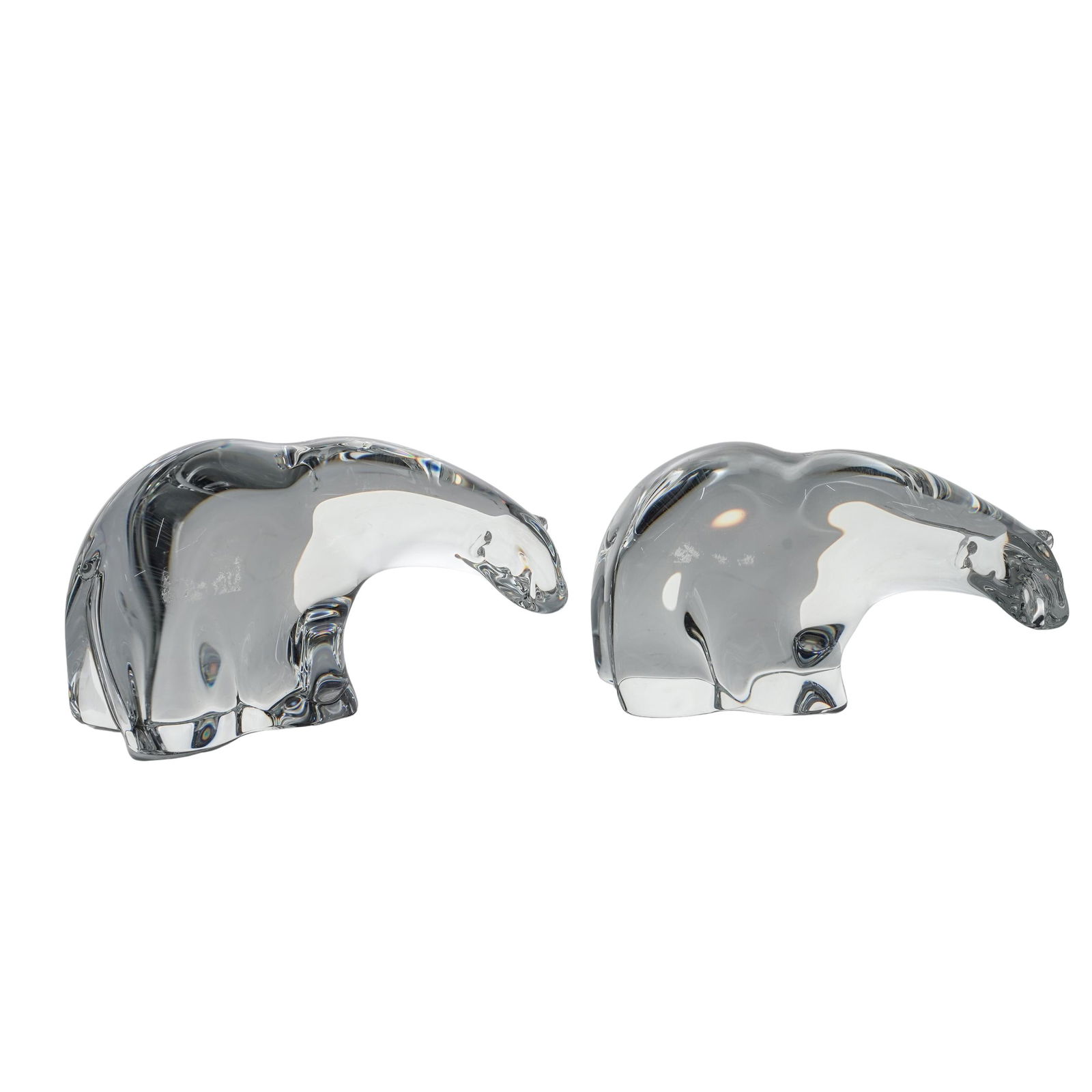(2pc) Steuben Crystal Polar Bear Figures: (2pc) Steuben Crystal Polar Bear FiguresEarly to mid 20th Cent.USATwo crystal figurines of polar bears. The bears are sculpted in a stylized, arched posture with their heads lowered. Signed Steuben on