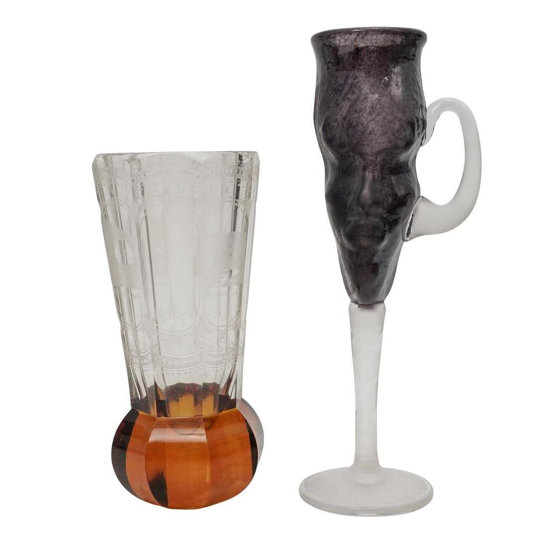 (2pc) Antique German Intaglio Highball and Art Glass Cup: (2pc) Antique German Intaglio Highball and Art Glass Cup20th Germany, Continental(1) Antique German Intaglio cut glass high ball cup with an amber base.(1) Figural amethyst cup with handle signed alon