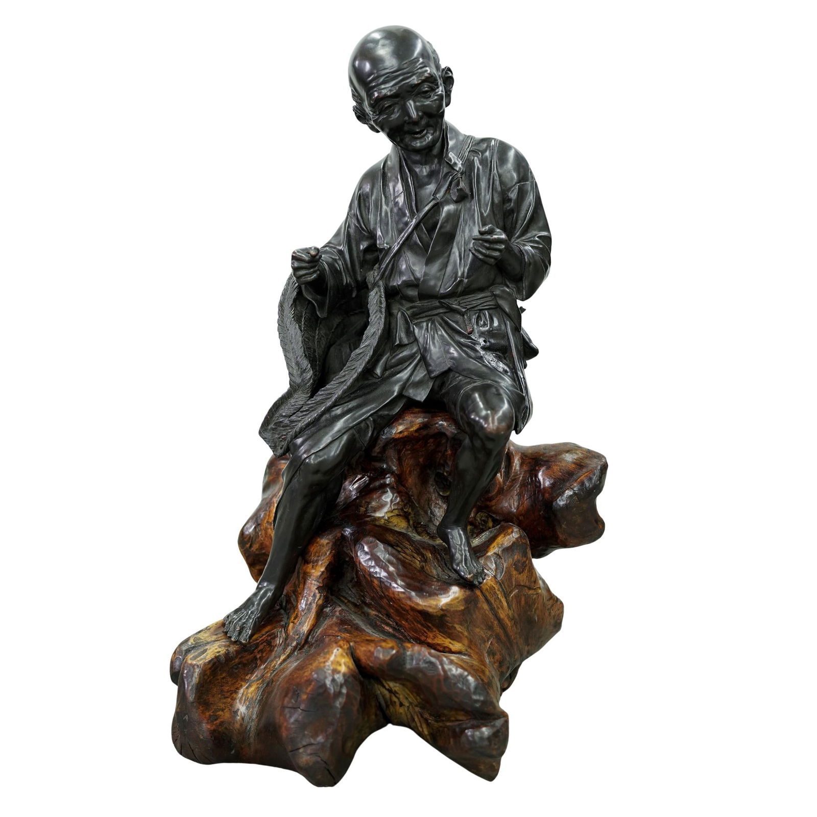 Japanese Meiji Tokyo School Bronze Okimono on Wood Base: Japanese Meiji Tokyo School Bronze Okimono on Wood Base1868-1912, JapanA Japanese Meiji period Tokyo School sculpted bronze okimono of a seated male figure, likely a labourer. Root-form wood base.H 30