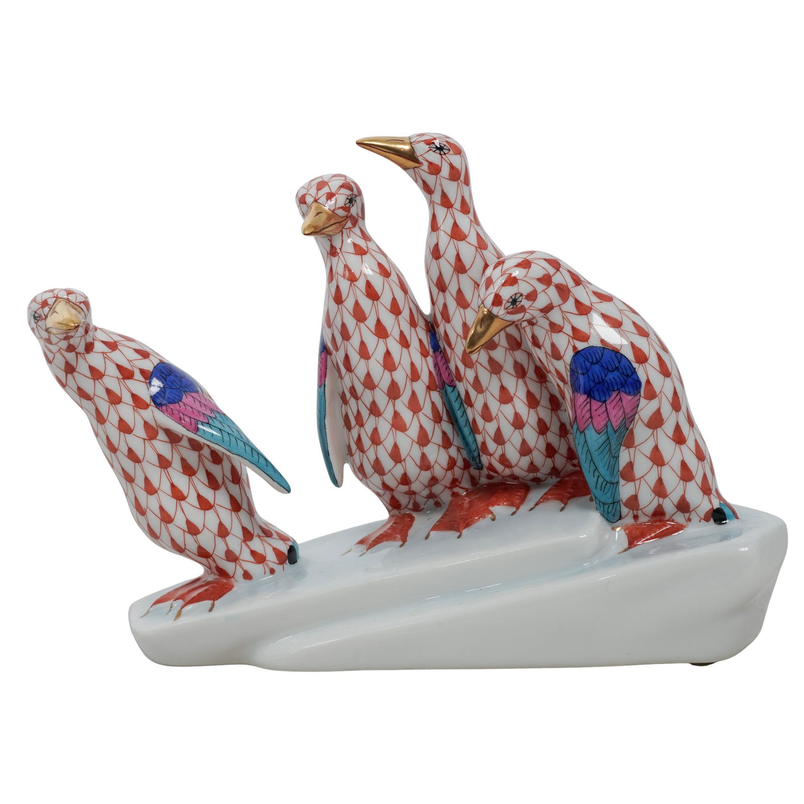 Herend Rust Fishnet "Penguins on Ice" Porcelain Figurine: Herend Rust Fishnet "Penguins on Ice" Porcelain Figurine20th c., HungaryPorcelain grouping of penguins hand-painted in the rust fishnet pattern with multi-color wings, orange feet, and 24k gold accent