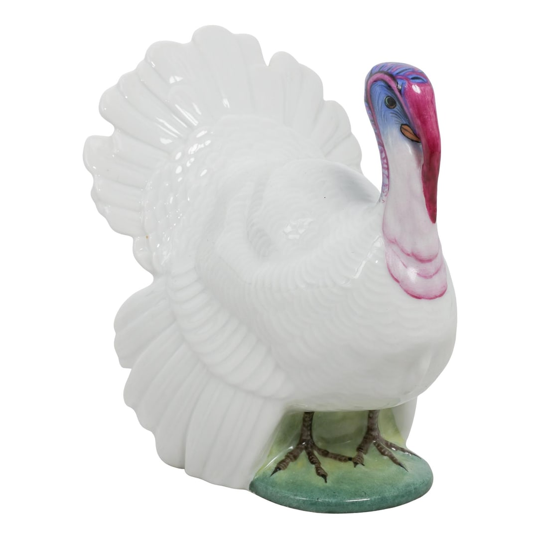 Herend Porcelain Turkey Figurine: Herend Porcelain Turkey Figurine20th c., HungaryPorcelain turkey figurine hand-painted with a white glazed body and blue and pink head. Stamped with Herend hallmark on the underside.H: 4.75" W: 3.75"