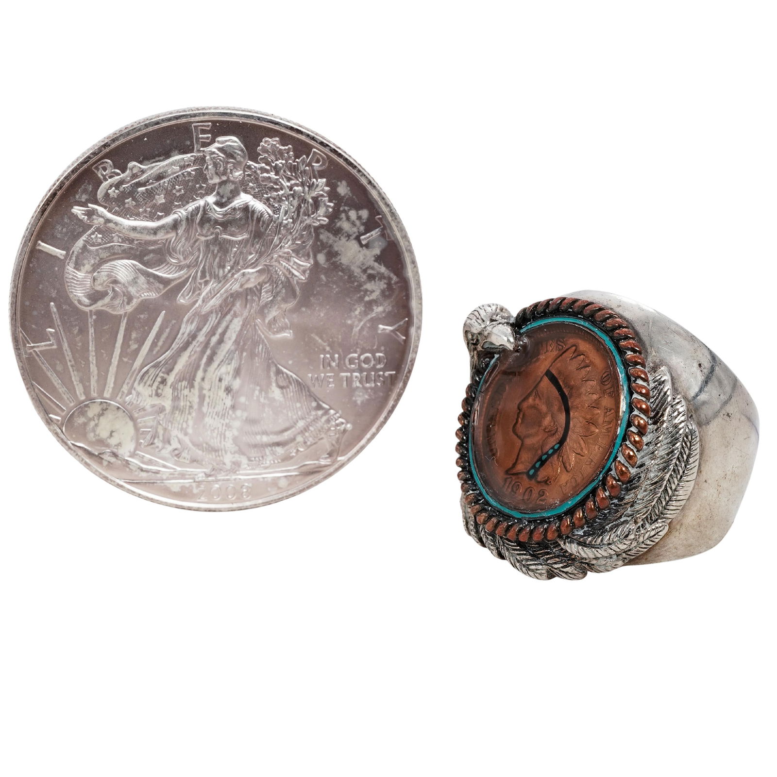 (2 Pcs) Silver Coin Ring and 2003 American Silver Eagle Coin: (2 Pcs) Silver Coin Ring and 2003 American Silver Eagle Coin 2000s, USA This lot consists of two silver items: a handcrafted silver coin ring and a United States one-ounce silver bullion coin. The