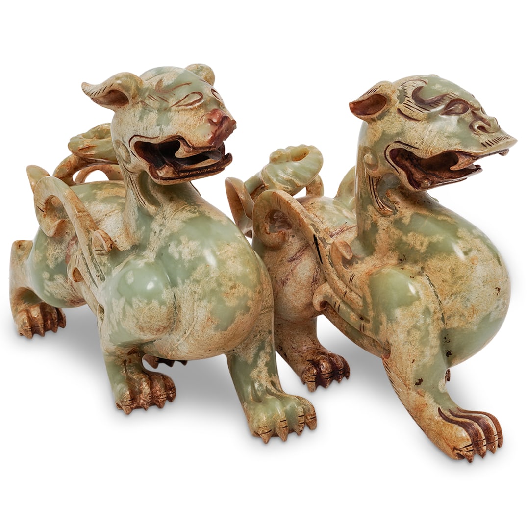 Pair Chinese Carved Hardstone Mythical Guardian Figures: Pair Chinese Carved Hardstone Mythical Guardian Figures 20th Cent., China A pair of carved hard stone guardian figures, modeled as stylized mythical dogs or lions in a seated stance. Each figure is