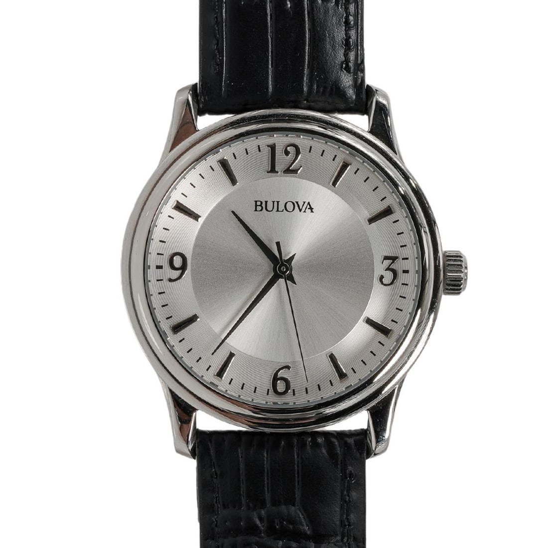 Bulova Stainless Steel Quartz Watch: Bulova Stainless Steel Quartz WatchCirca 1990s-2000s, SwissStainless steel Bulova wristwatch featuring a silver sunburst dial with applied Arabic numerals at 12, 3, 6, and 9, complemented by applied b