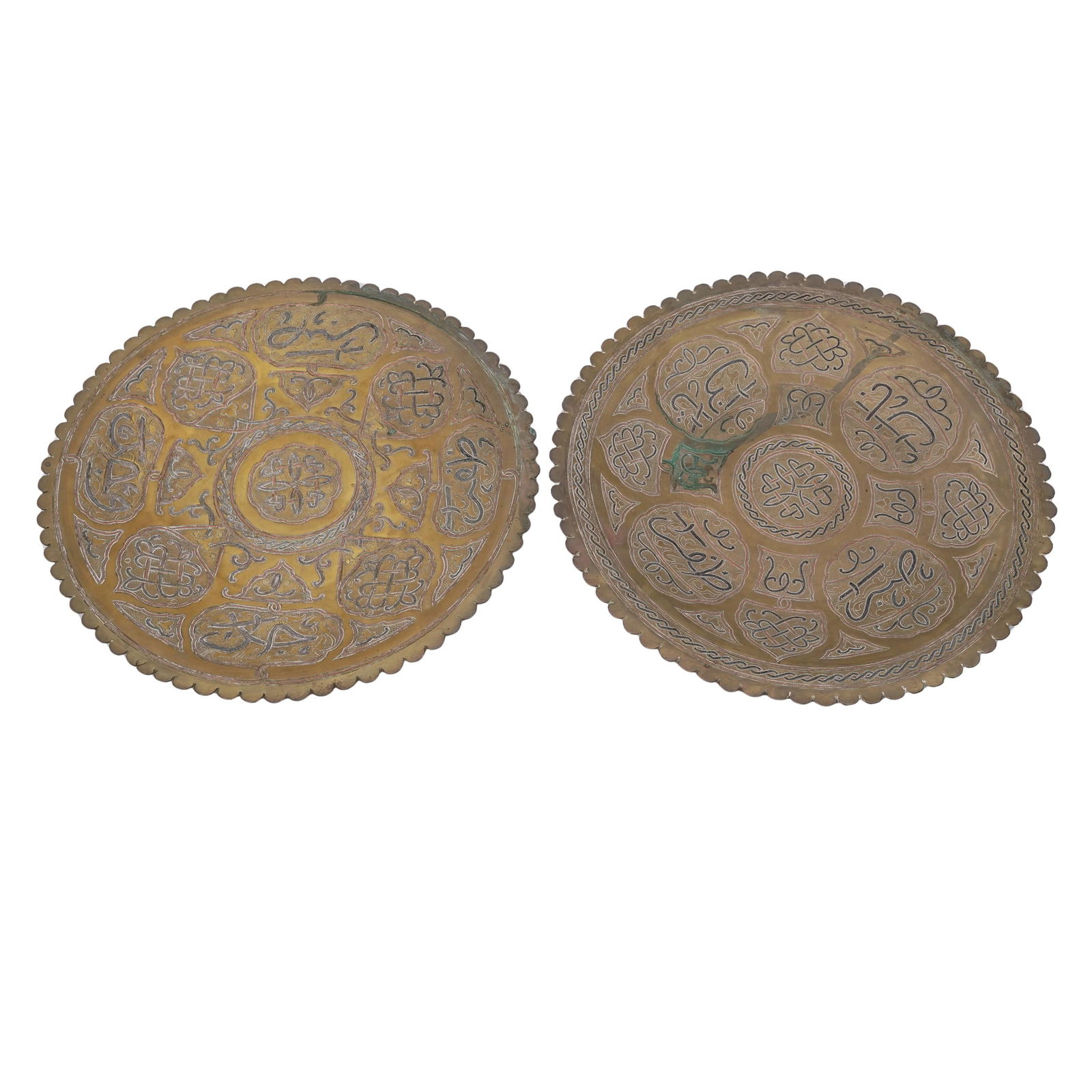 Pair of Middle Eastern Ornate Damascene Brass Trays: Pair of Middle Eastern Ornate Damascene Brass Trays Early 20th century, Middle Eastern Middle Eastern brass serving trays, featuring intricate hand-etched designs and Arabic calligraphy with silvered
