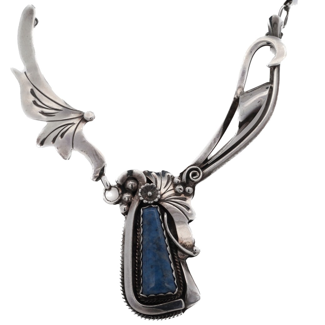 Carolyn Sandoval Navajo Sterling & Lapis Lazuli Necklace: Carolyn Sandoval Navajo Sterling & Lapis Lazuli Necklace 20th c., USA Navajo Native American sterling silver necklace with a floral motif featuring a pendant set with a lapis lazuli gemstone. Carolyn 