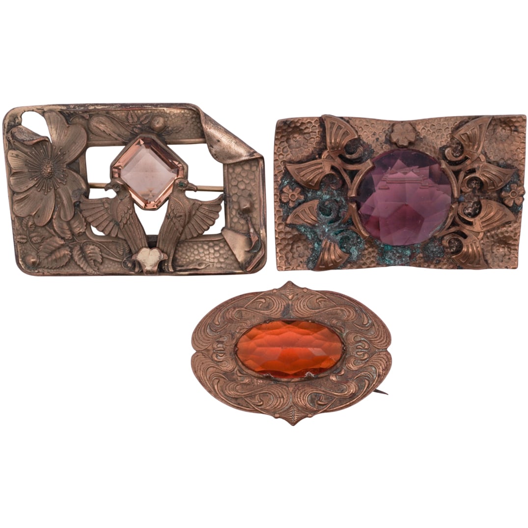 (3 Pc) Art Nouveau Brass & Stone Brooches: (3 Pc) Art Nouveau Brass & Stone Brooches1910s to 1930sGroup of (3) art nouveau brass brooches, consisting of:(1) brooch of rectangular form, centered be a pair of birds facing away from each other be