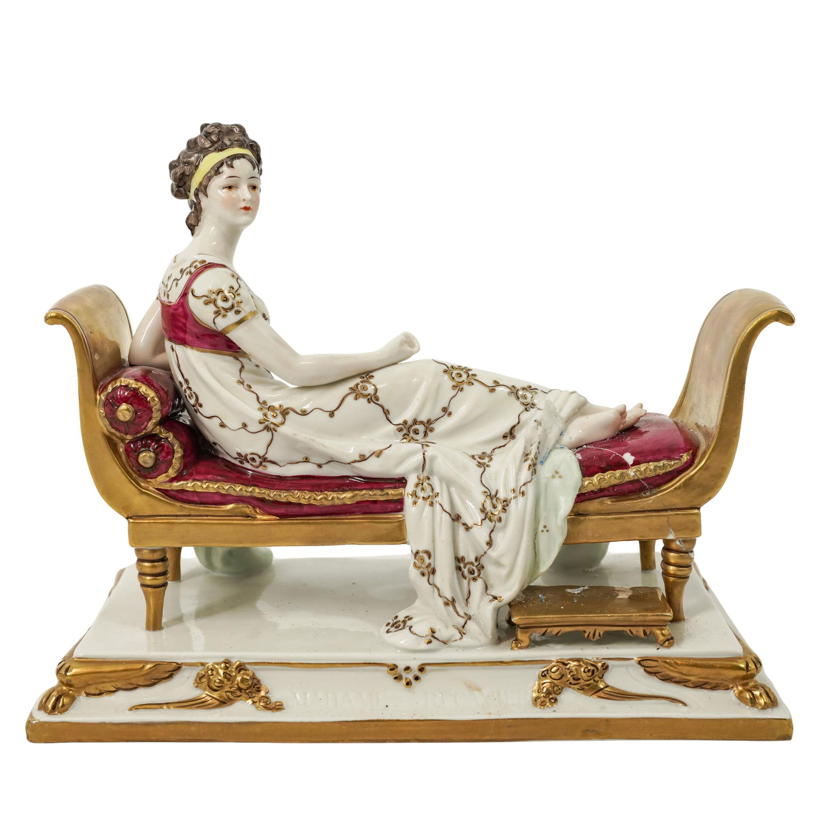 German Porcelain Reclining Regency Female Figure: German Porcelain Reclining Regency Female FigureLate 19th-early 20th century, GermanyA German hand-painted reclining porcelain female figure in Regency Era dress and gilt accenting. Marked "Germany" o
