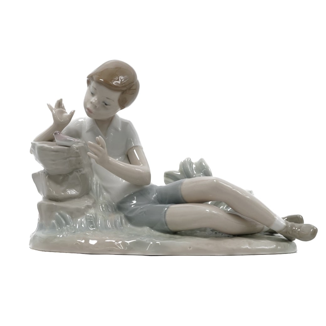 Lladro Spain "Boy with Bird" Porcelain figurine: Lladro Spain "Boy with Bird" Porcelain figurine20th century, SpainVintage Lladro Spain Titled “Boy with Bird” porcelain figurine.Issued 1974, retired in 1981.Signed on the bottom.L. 9" x H. 6.
