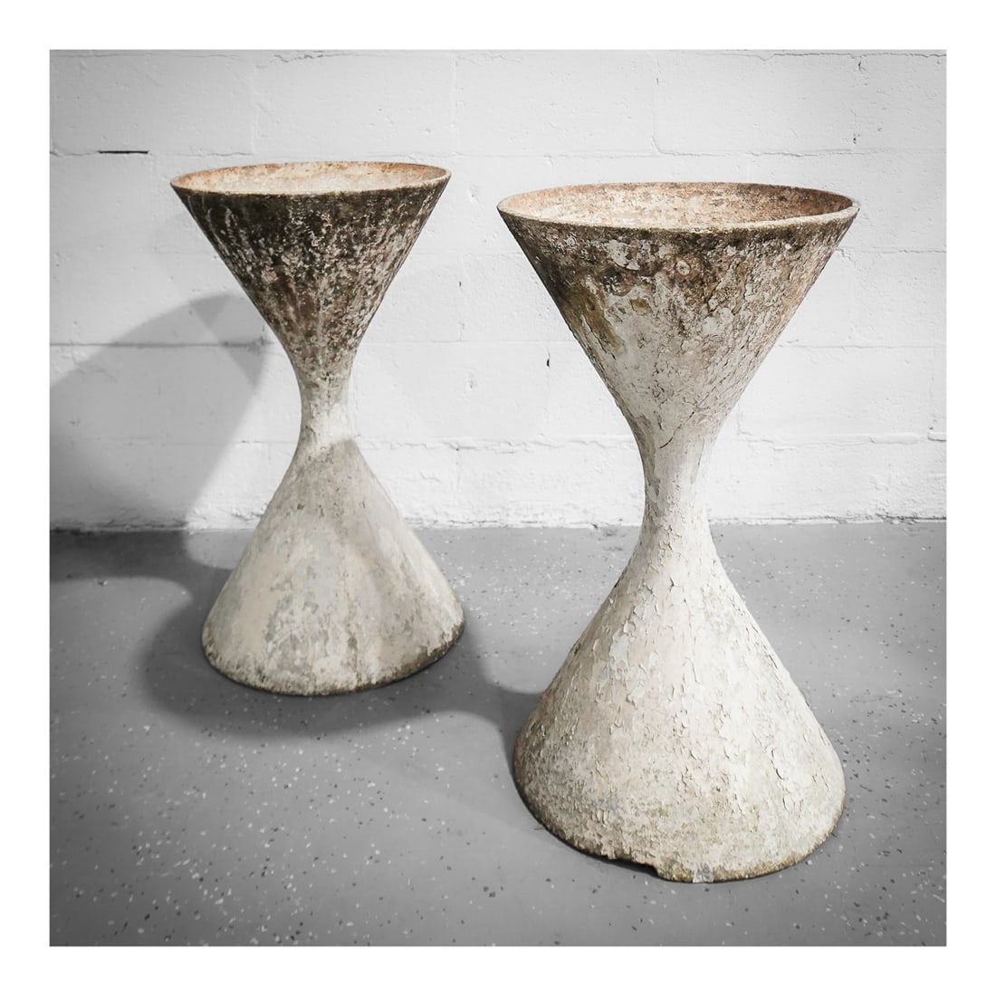 Pair of Willy Guhl (Swiss, 1915-2004) Concrete "Diablo" Planters: Pair of Willy Guhl (Swiss, 1915-2004) Concrete "Diablo" Planterscirca 1960s, SwissA pair of Willy Guhl (Swiss, b. 1915 d. 2004) concrete "diablo" planters.H 31 1/2” Diameter 18”