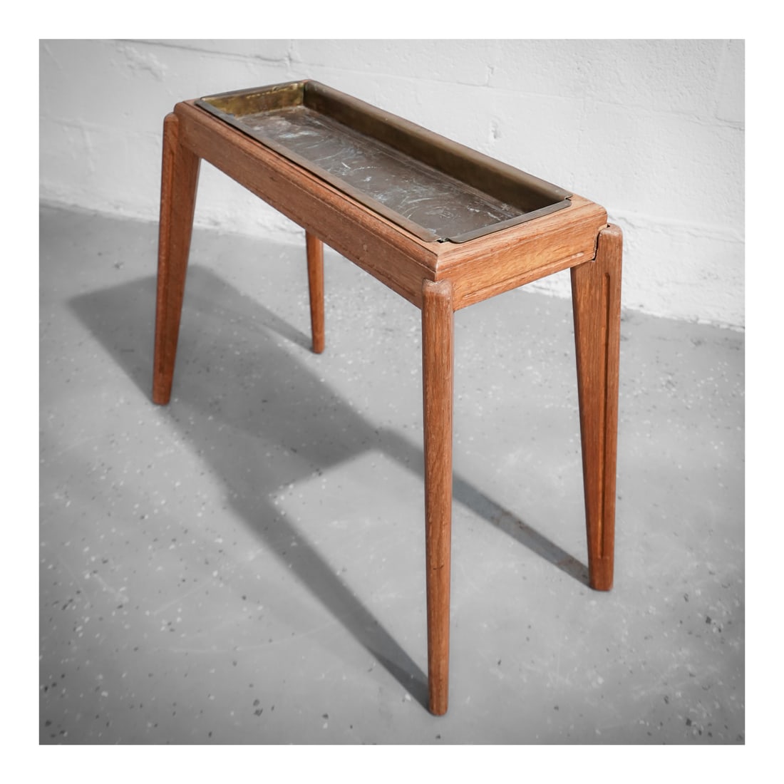 Mid Century Metal and Wood Tray Table: Mid Century Metal and Wood Tray Tablecirca 1960s, ContinentalA mid century modern tray table with a wood frame and legs and a metal tray insert.H 29" W 12 1/2" L 28"