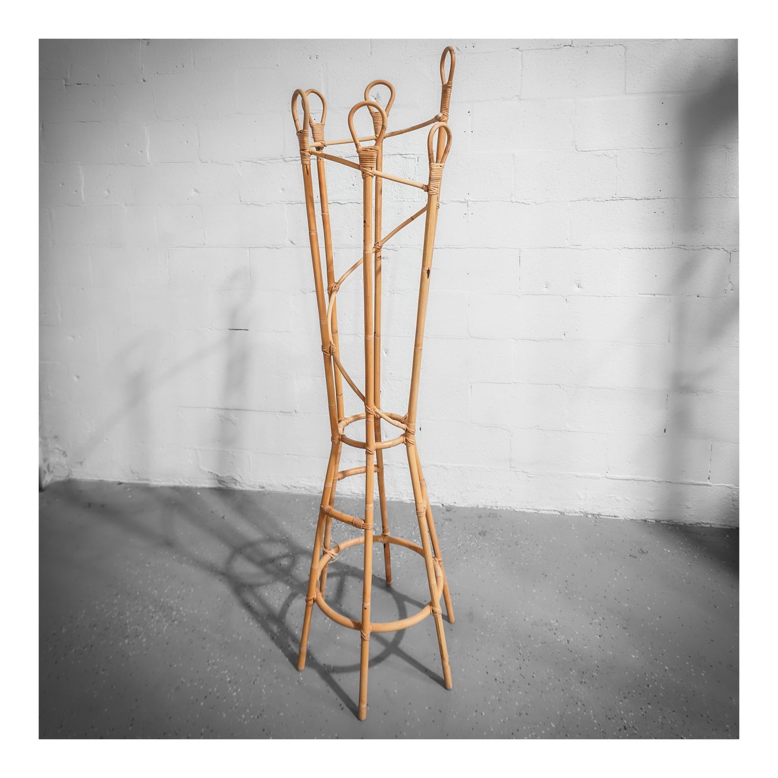 Roger Feraud (French, 20th century) Rattan Coat Rack: Roger Feraud (French, 20th century) Rattan Coat Rackcirca 1970s, Frencha rattan coat rack in a modern style with looped tops and a swirl element through center designed by Roger Feraud (French, 20th c