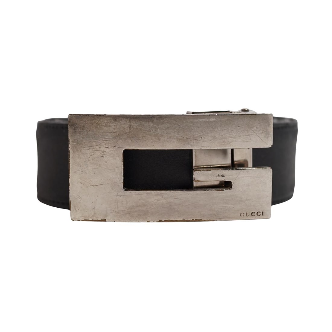 Vintage Black Leather Gucci "G" Buckle Belt: Vintage Black Leather Gucci "G" Buckle Belt20th century, ItalyA vintage black leather Gucci belt featuring a silver-plated "G" buckle. Buckle marked "Gucci". Belt is marked, faded, "Gucci Italy... 90