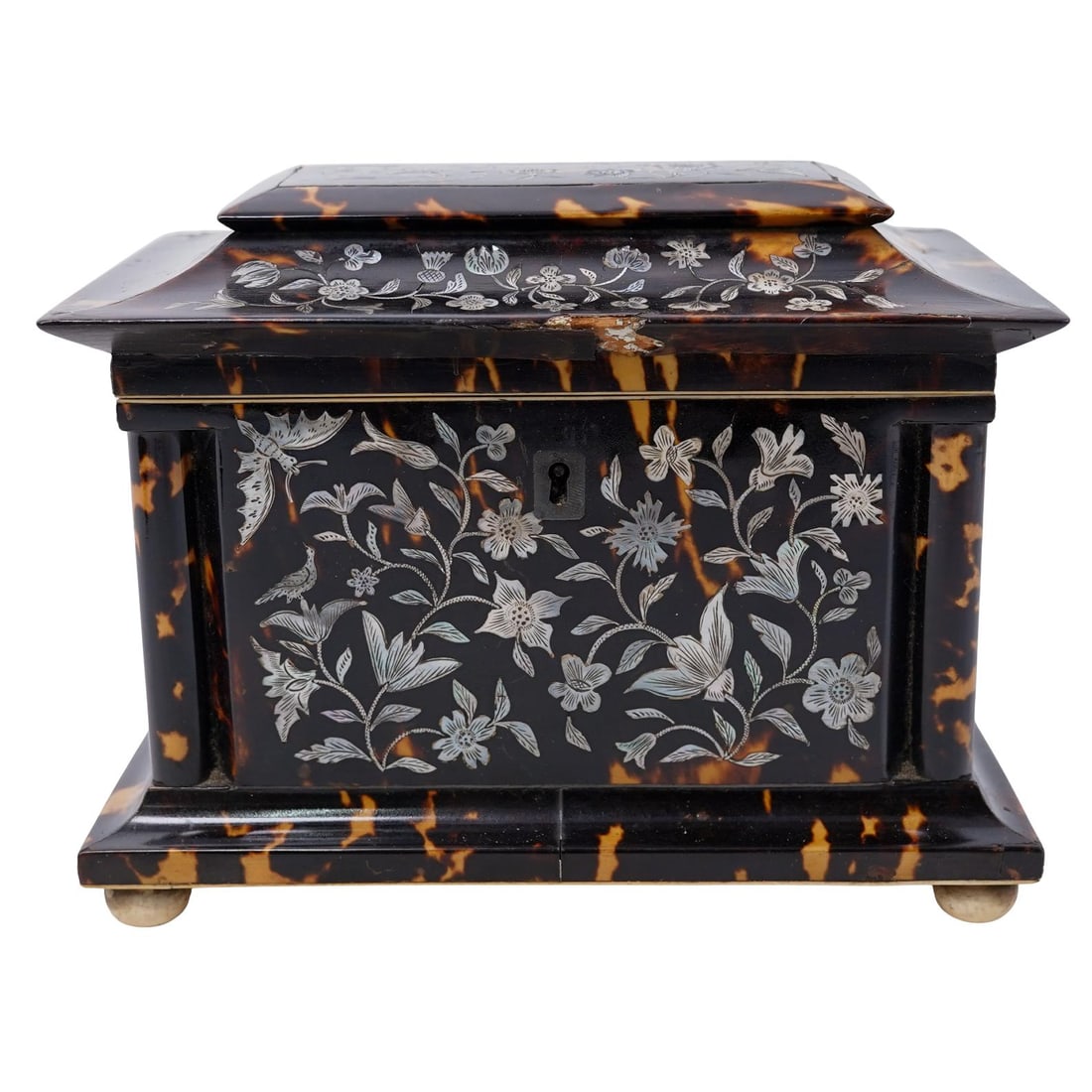 Antique Tortoise-Hued and Mother of Pearl Floral Inlay Tea Caddy: Antique Tortoise-Hued and Mother of Pearl Floral Inlay Tea CaddyLate 19th-early 20th century, ContinentalAn antique tortoise-hued wooden tea caddy with carved bone accents. Two lidded compartments. Mo