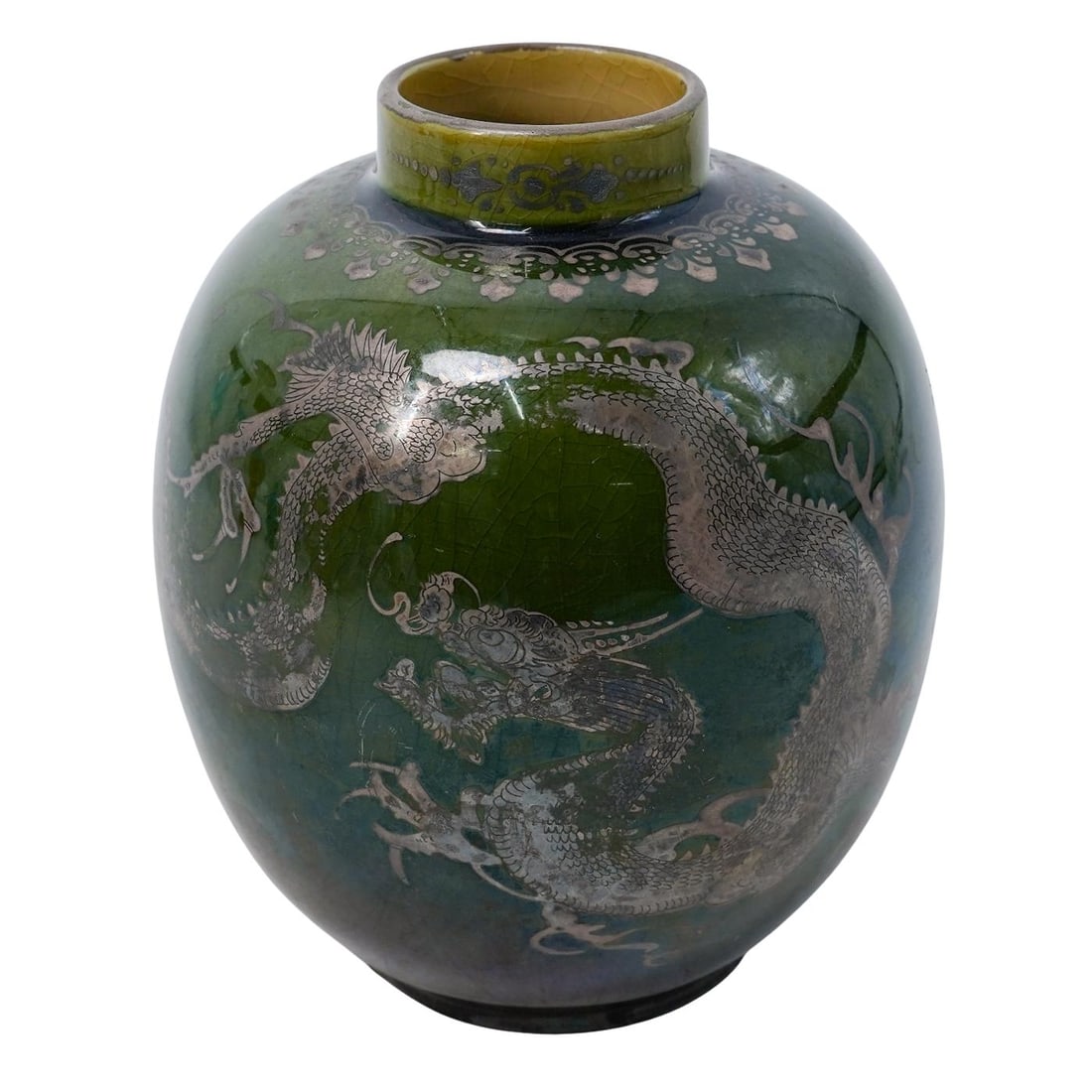 Antique Japanese Silver Overlay and Ceramic Vase: Antique Japanese Silver Overlay and Ceramic Vase20th century , JapanAntique Japanese Silver Overlay green Porcelain Dragon Motif Vase.Stamped on the base.H. 5.5" x W. 4.5" inches
