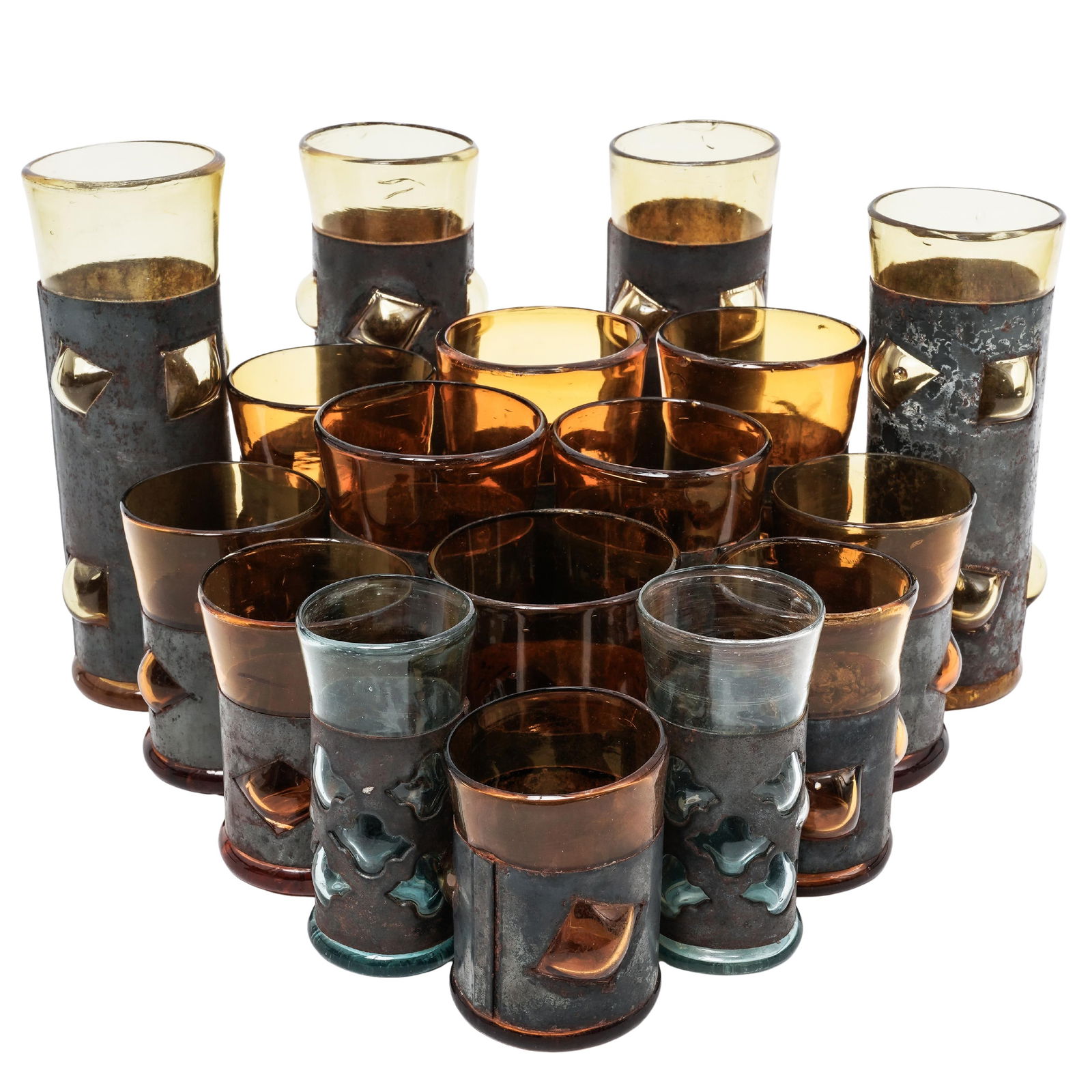 (17pc) Vintage Felipe Derflinger Tumbler Glasses: (17pc) Vintage Felipe Derflinger Tumbler GlassesMid 20th Cent. MexicanBrutalist amber and green metal imprisoned tumblers glassesSmallest: H: 3" Dia: 2.1/4" Largest: H: 7" Dia: 2.1/2"